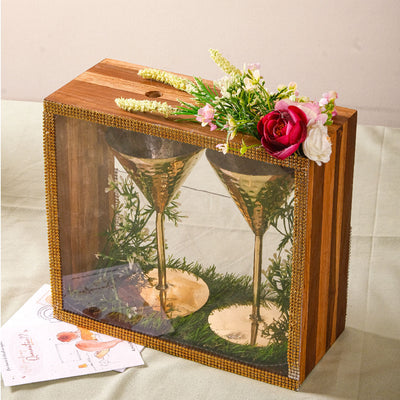 Brass cocktail glasses in wooden box